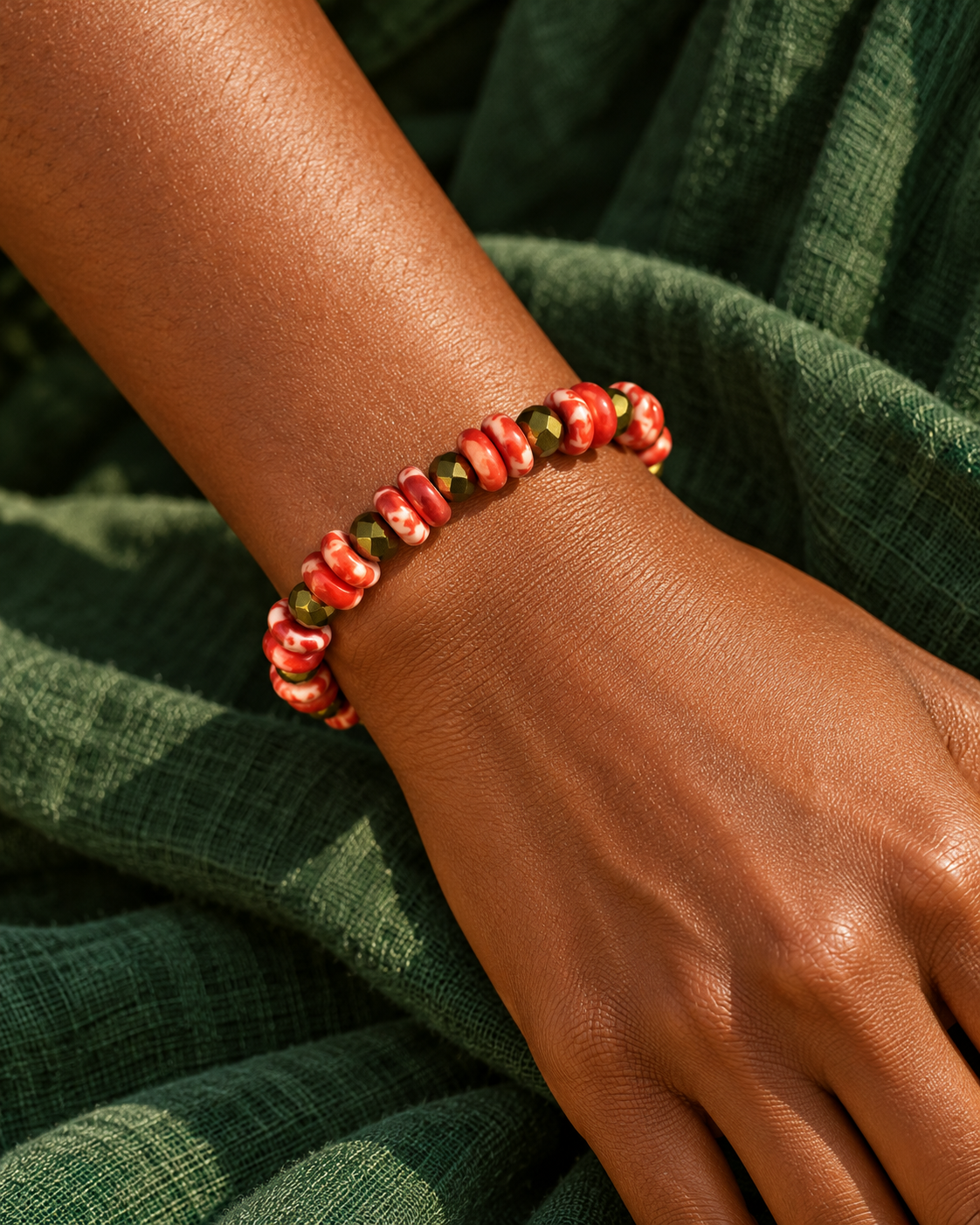 Red and gold beaded bracelet styled on a wrist