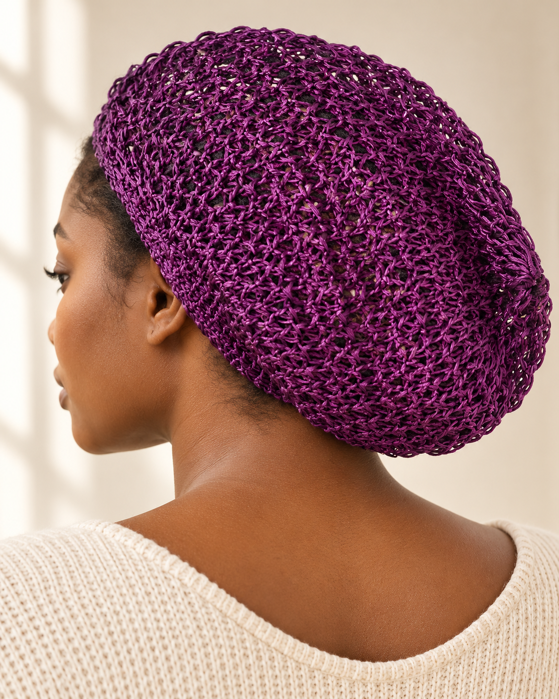 Purple crochet bonnet worn on a model