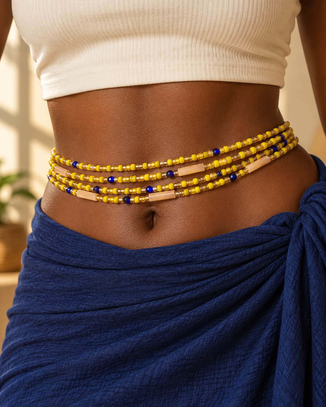 Yellow waist beads worn around the waist